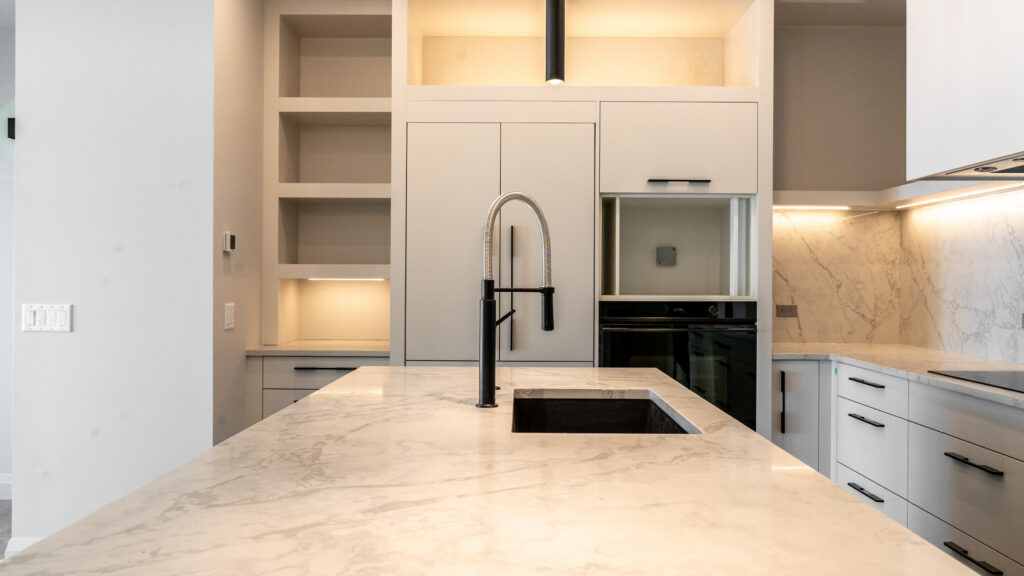 white modern kitchen with clean countertop and clean black accents